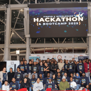 Group photo of all hackathon participants standing on stage at the UCT Financial Innovation Hub.